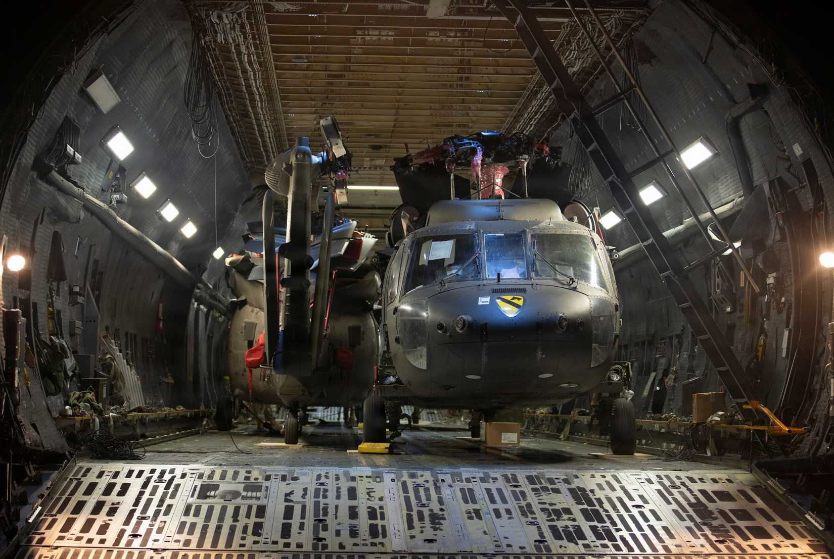 Four U.S. Army UH-60M Black Hawk helicopters sit in the cargo hold of a U.S. Air Force C-5M Super Galaxy assigned to the 22nd Airlift Squadron.-1