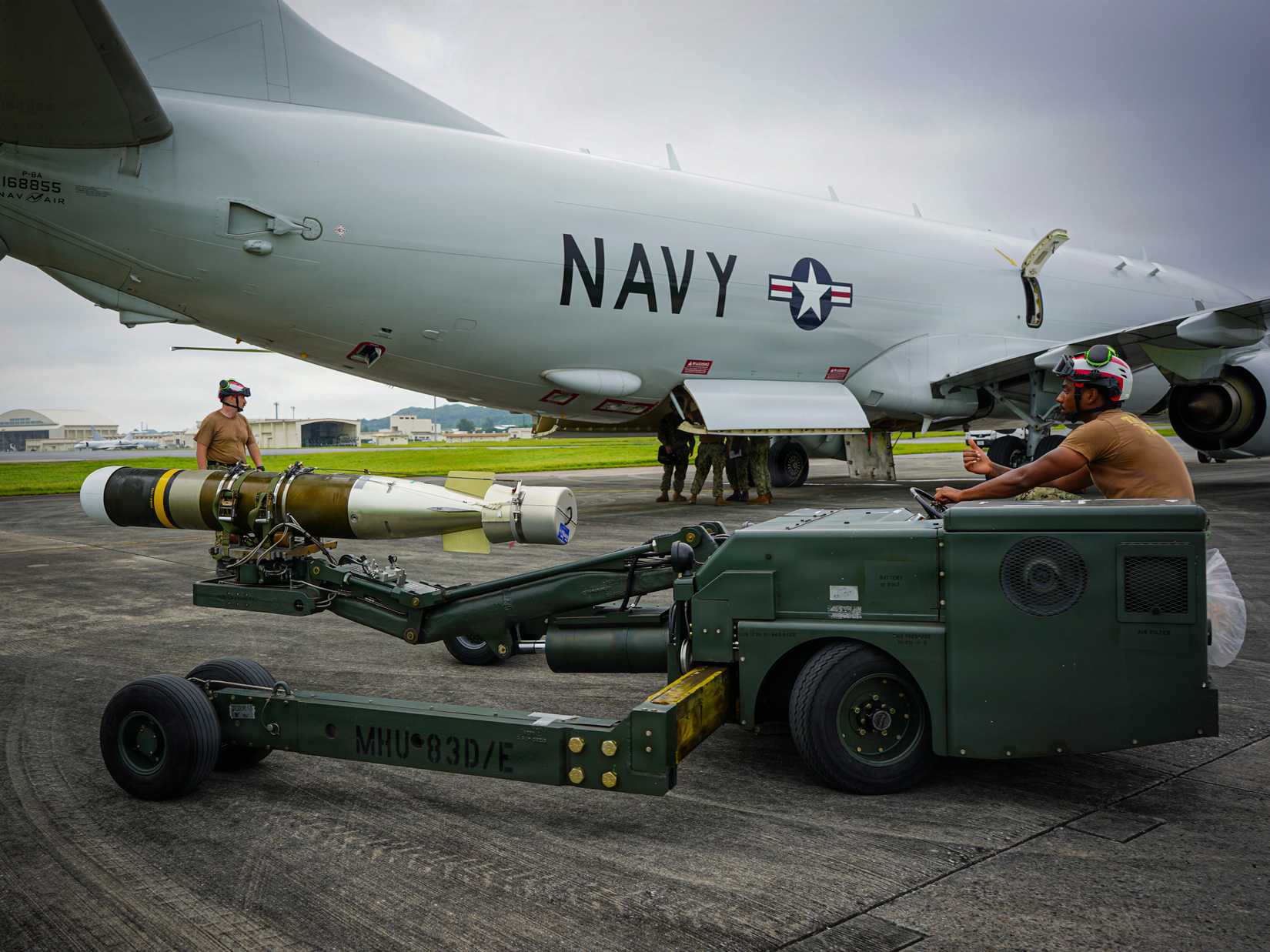 Navy Sailors assigned to Patrol and Reconnaissance (VP) 26 prepare to load a Mark 54 lightweight torpedo onto a P-8A Poseidon