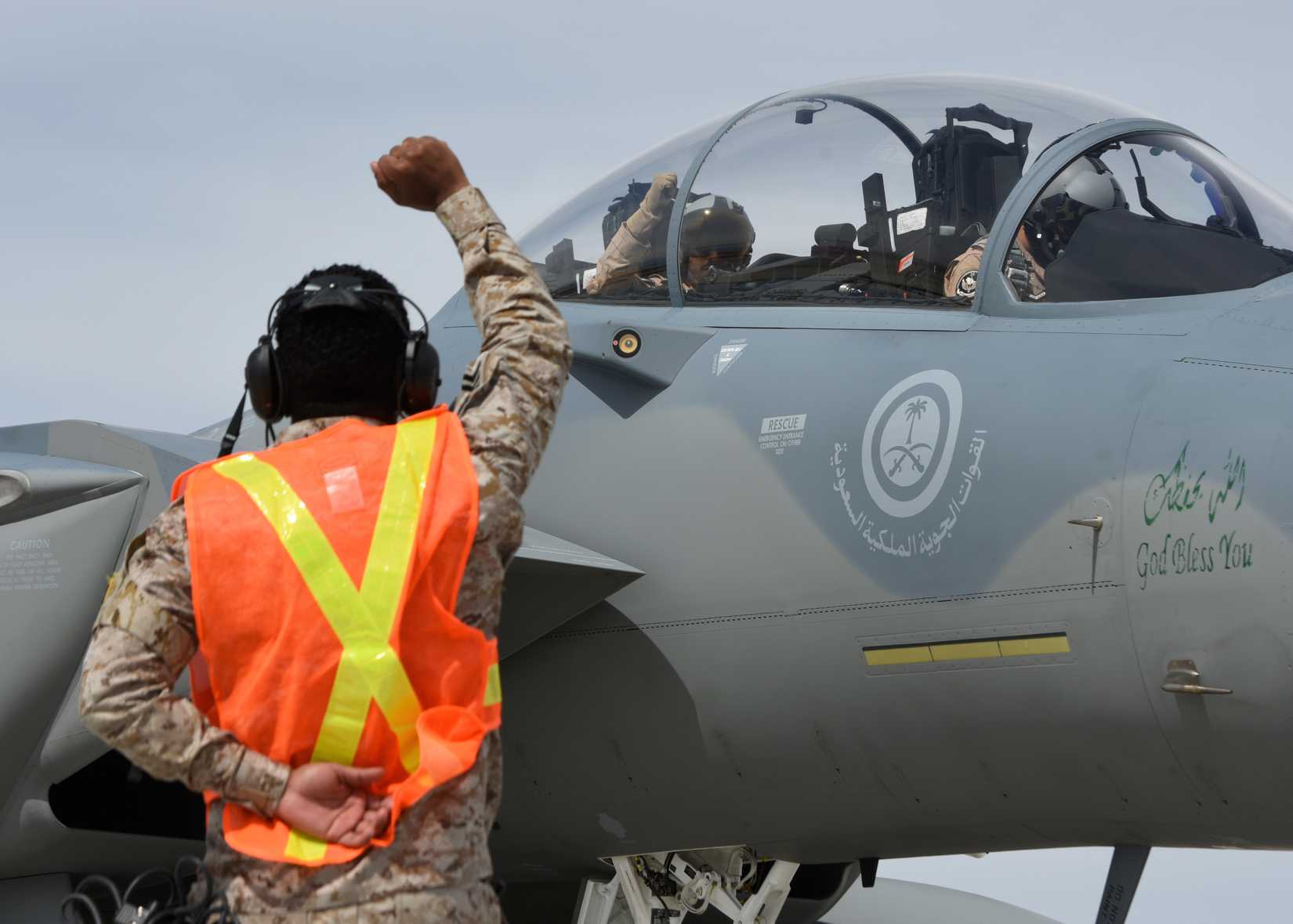 A Royal Saudi Air Force maintenance Airman gestures to the F-15SA aircrew via hand signals as they prepare for a mission during Red Flag 19-2