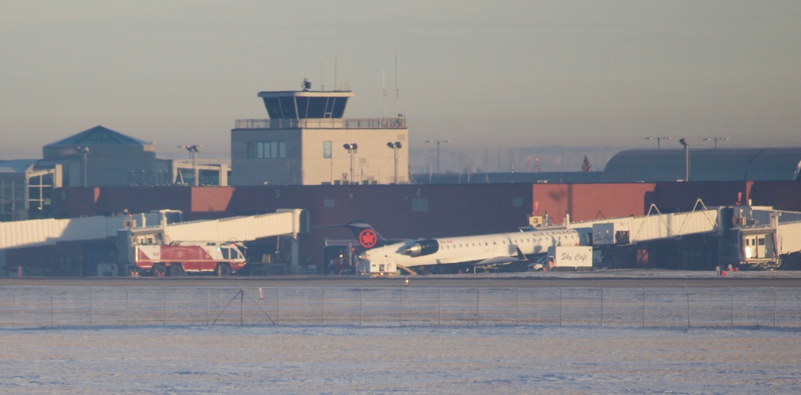 Catering Truck Gets Stuck Under Air Canada CRJ900 Lifting Plane