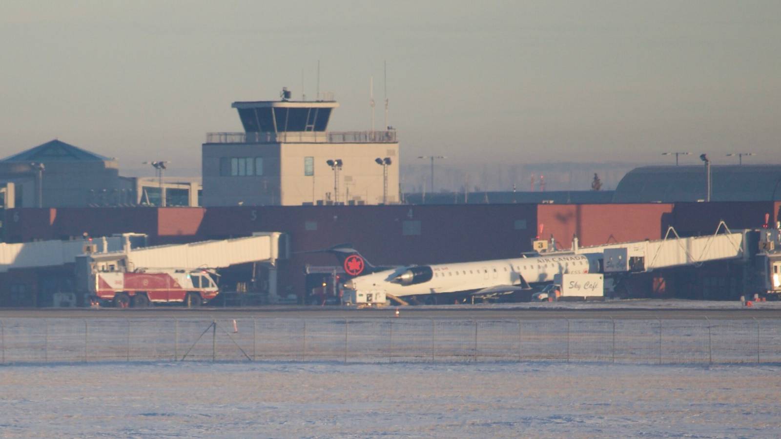 Catering Truck Gets Stuck Under Air Canada CRJ900 Lifting Plane