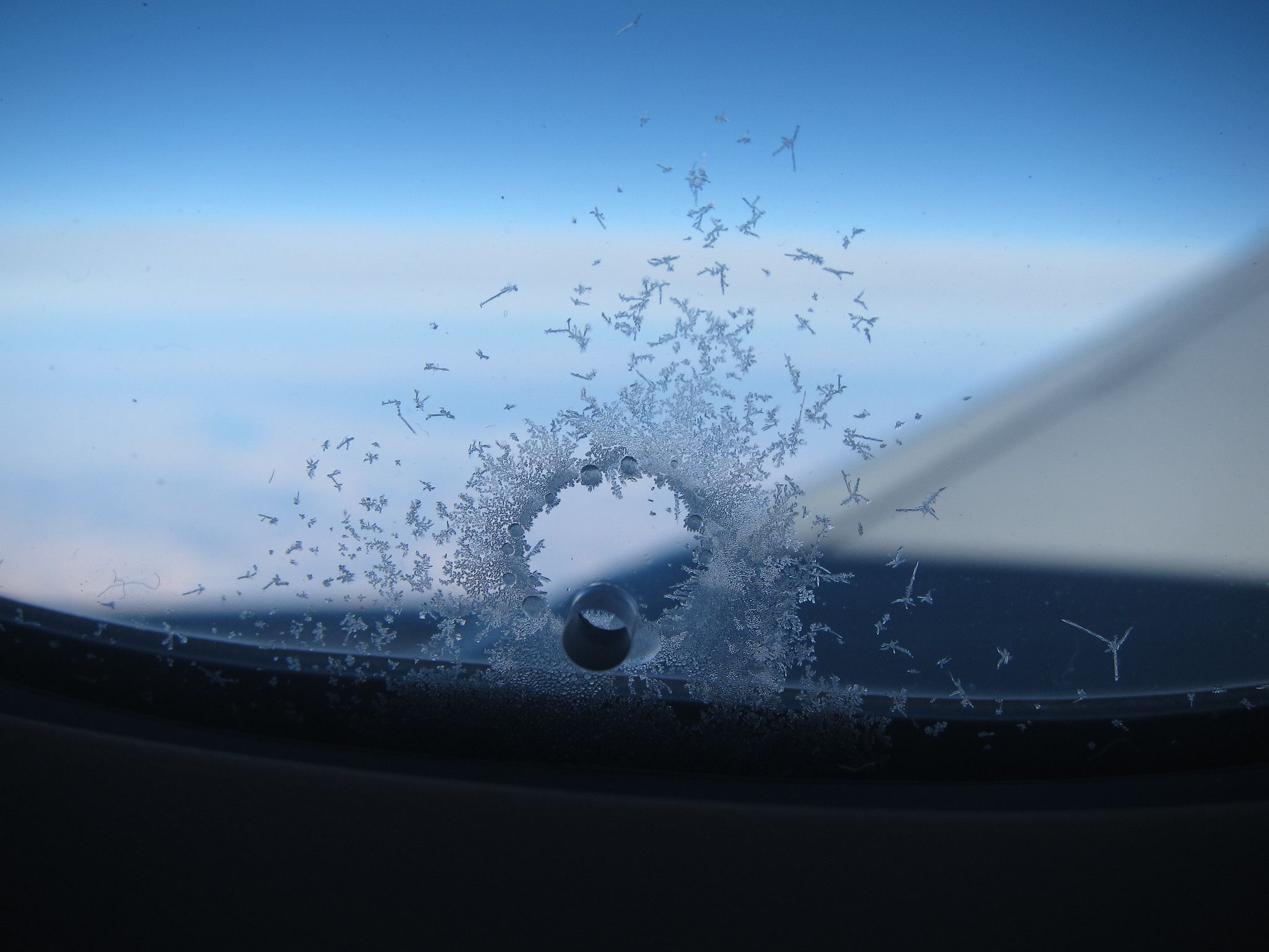 Small bleed hole in an aircraft window.