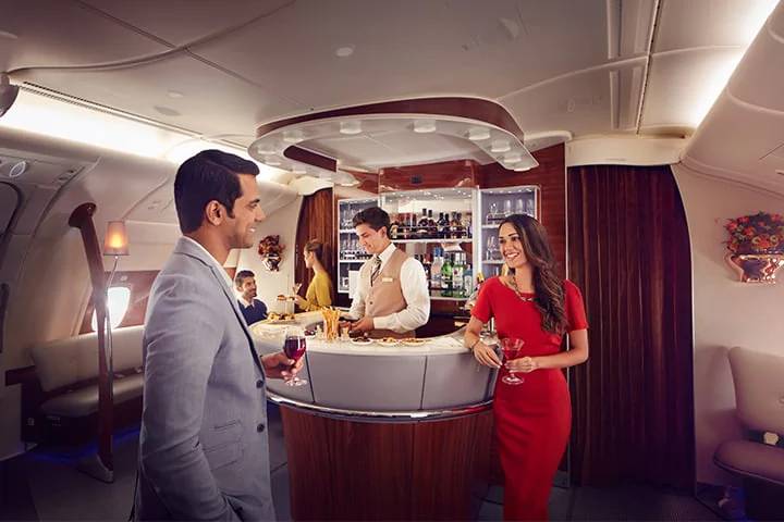 emirates a380 business class lounge bar with people chatting in the foreground