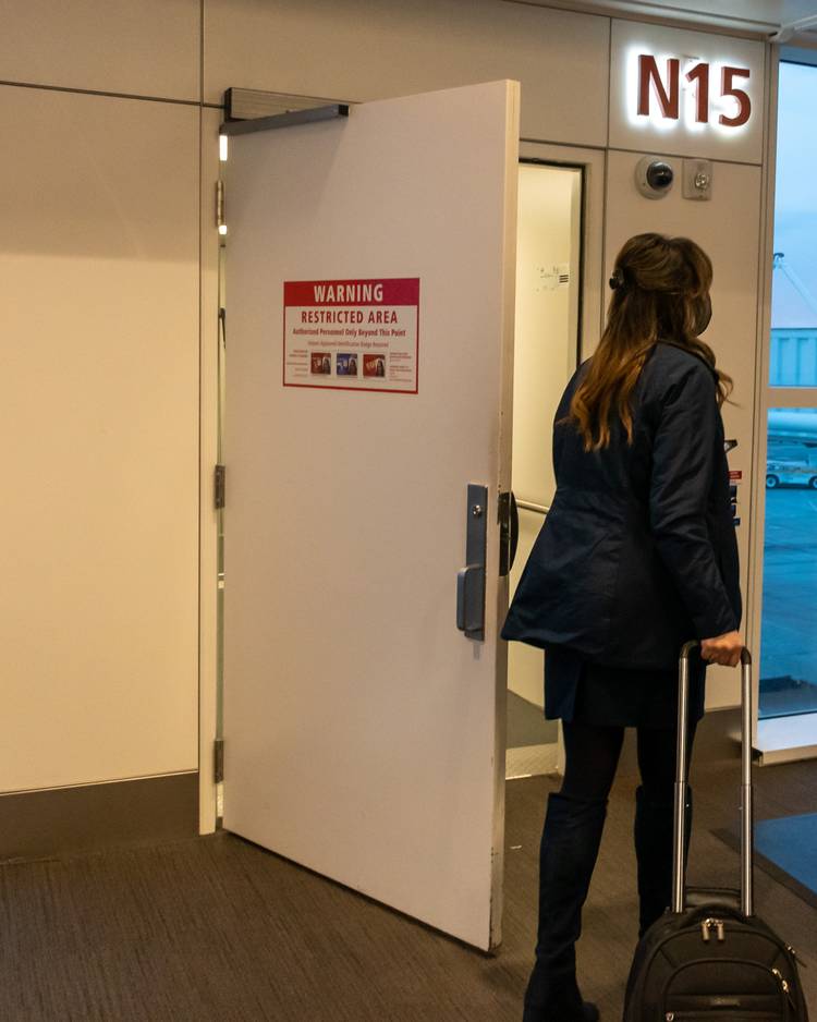 An Alaska Airlines Flight Attendant About to Board From Gate N15 - With the Door Open