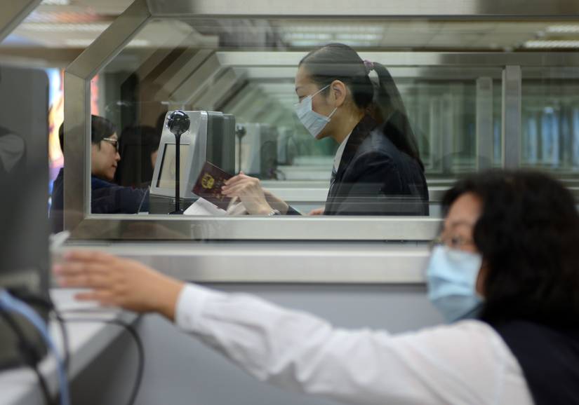 Immigration Officer Processing Passengers At Taipei Airport