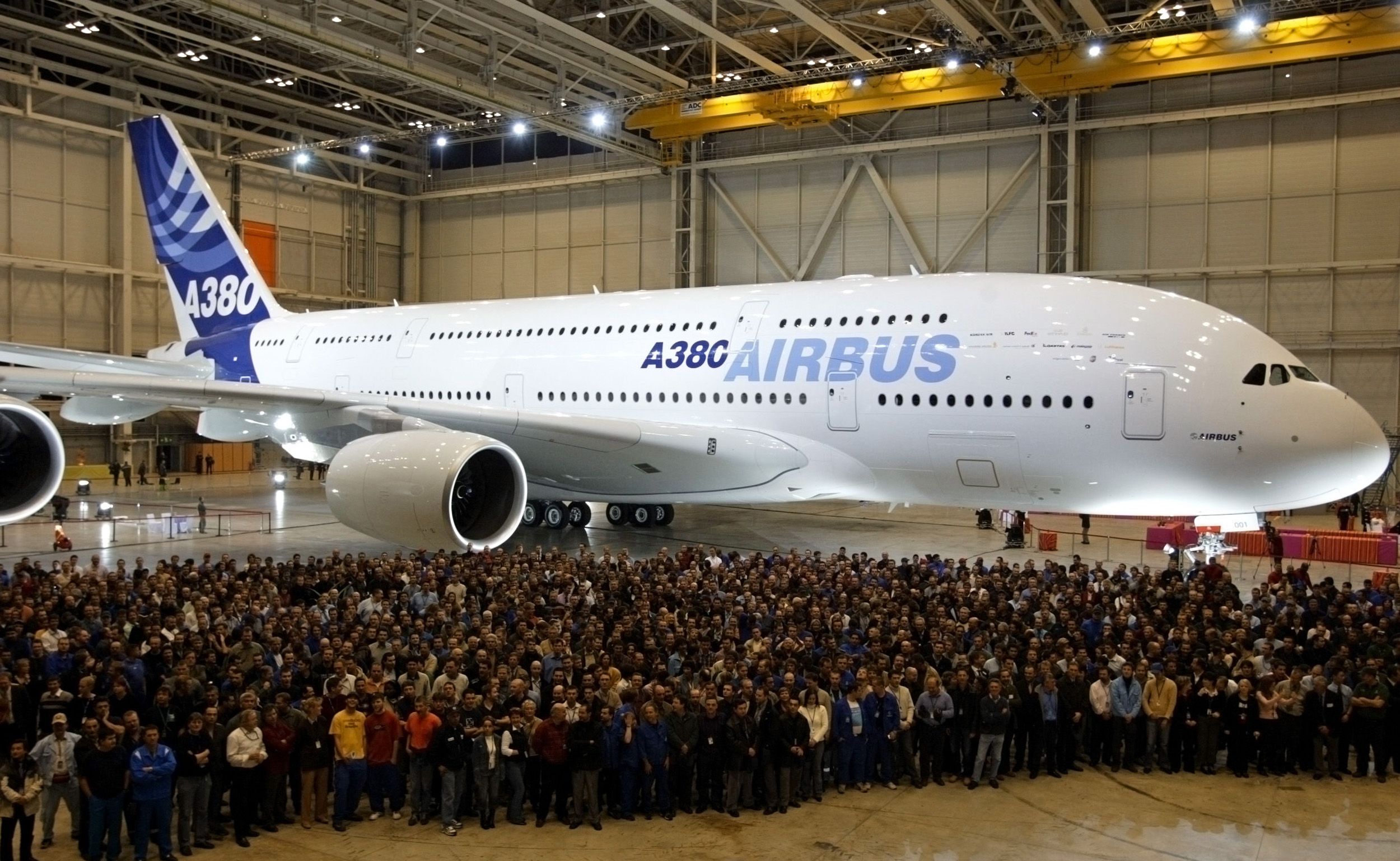 An Airbus A380 with a crowd of people in front of it