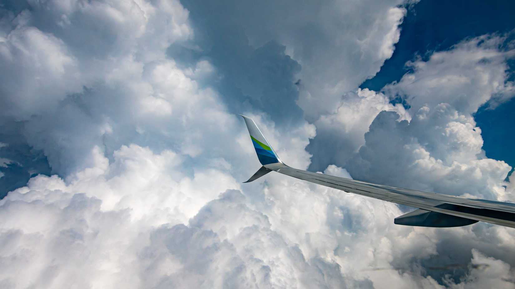 737-900ER Wing Astride Big Clouds at 9462.5 ft ASL.