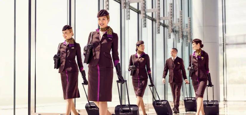 etihad airways cabin crew walking through airport