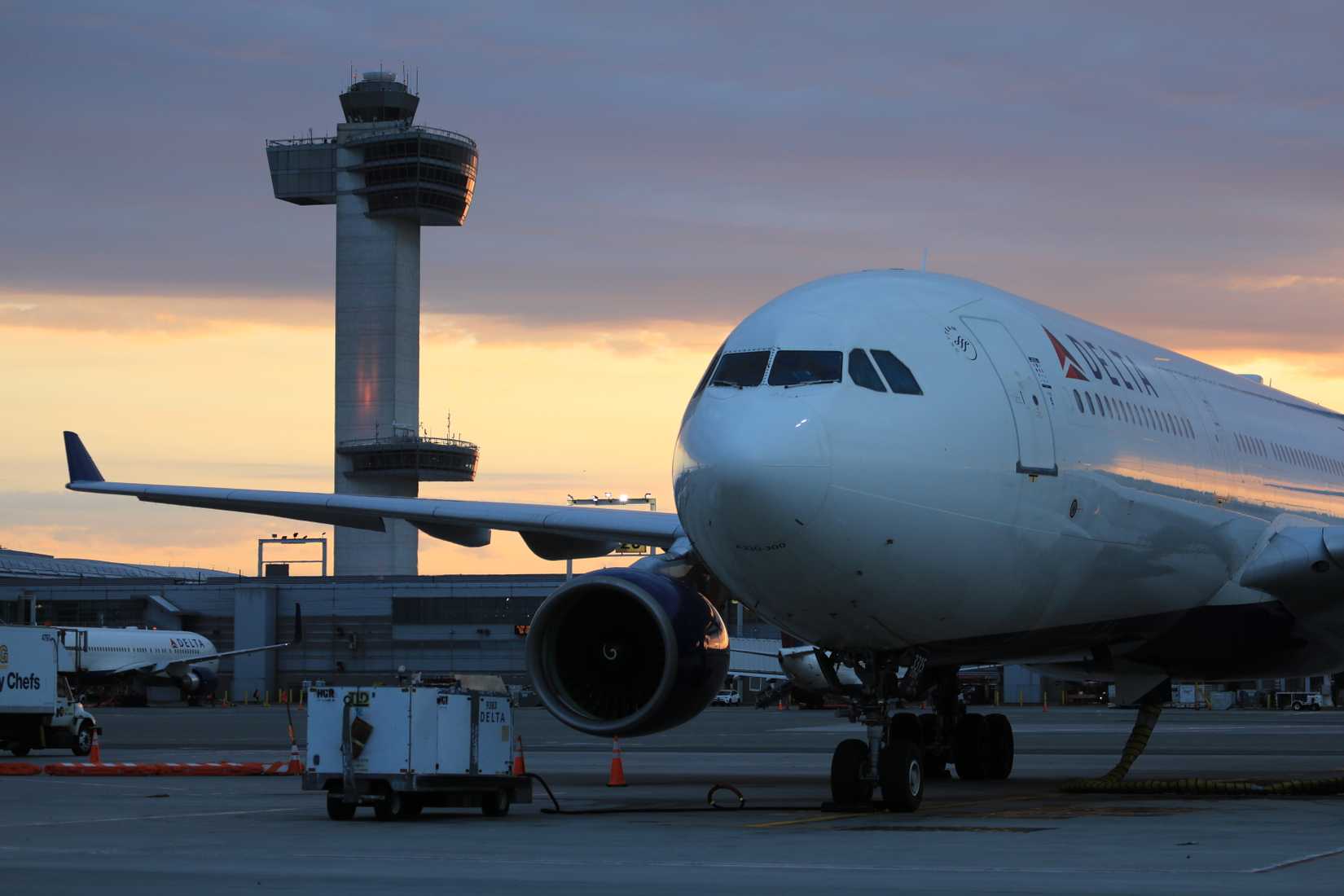 A Delta aircraft at JFK airport at sunset