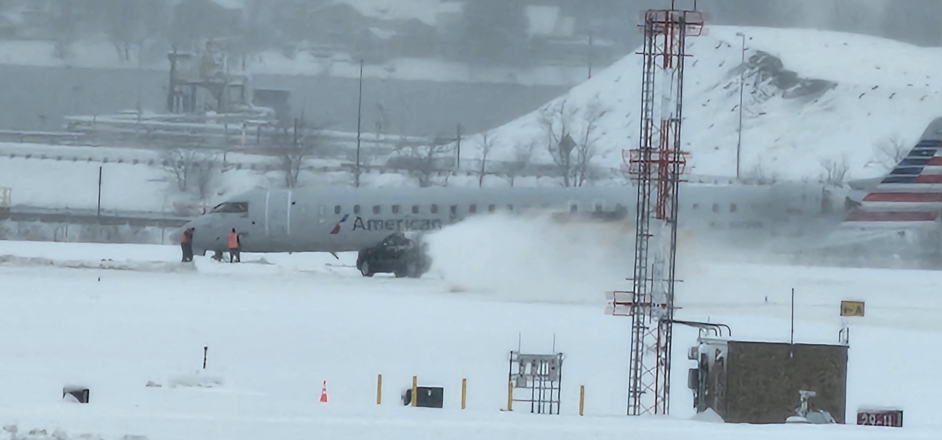 American Airlines Bombardier CRJ900 Slides Off Runway In the snow