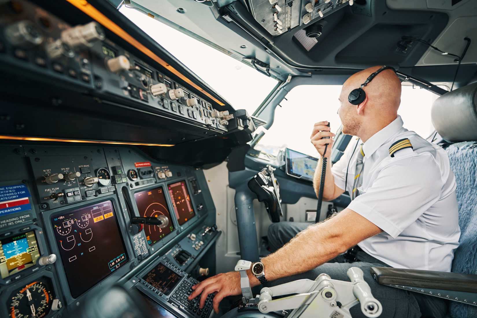A Boeing 737 pilot corresponding via the hand-held radio.
