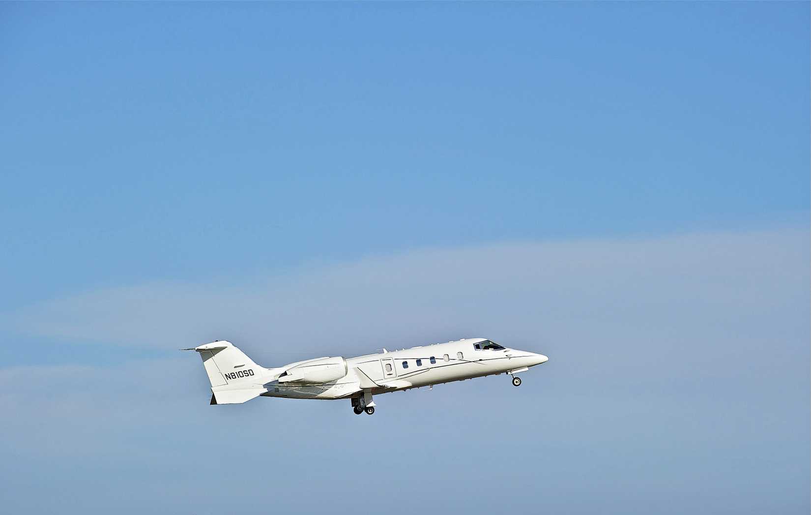A Bombardier Learjet 60 flying in the sky.