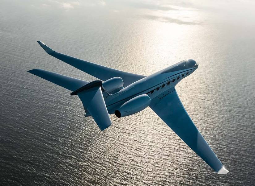 A Gulfstream Jet flying over water.
