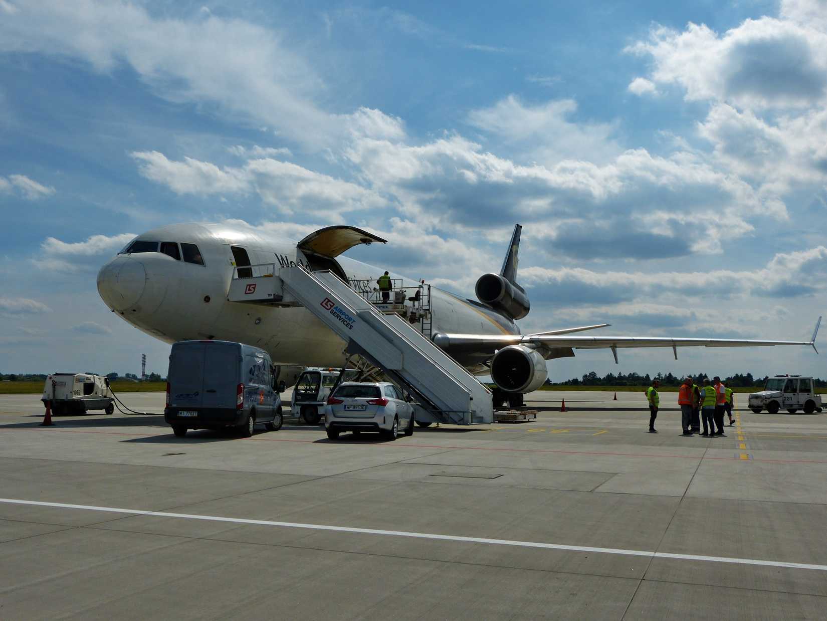 WARSAW, POLAND - 27 JUNE 2017: Loading cargo on the air freight logistics operated by United Parcel Service (UPS), McDonnell Douglas MD-11F (registration N291UP) at Warsaw Chopin Airport (EPWA/WAW)