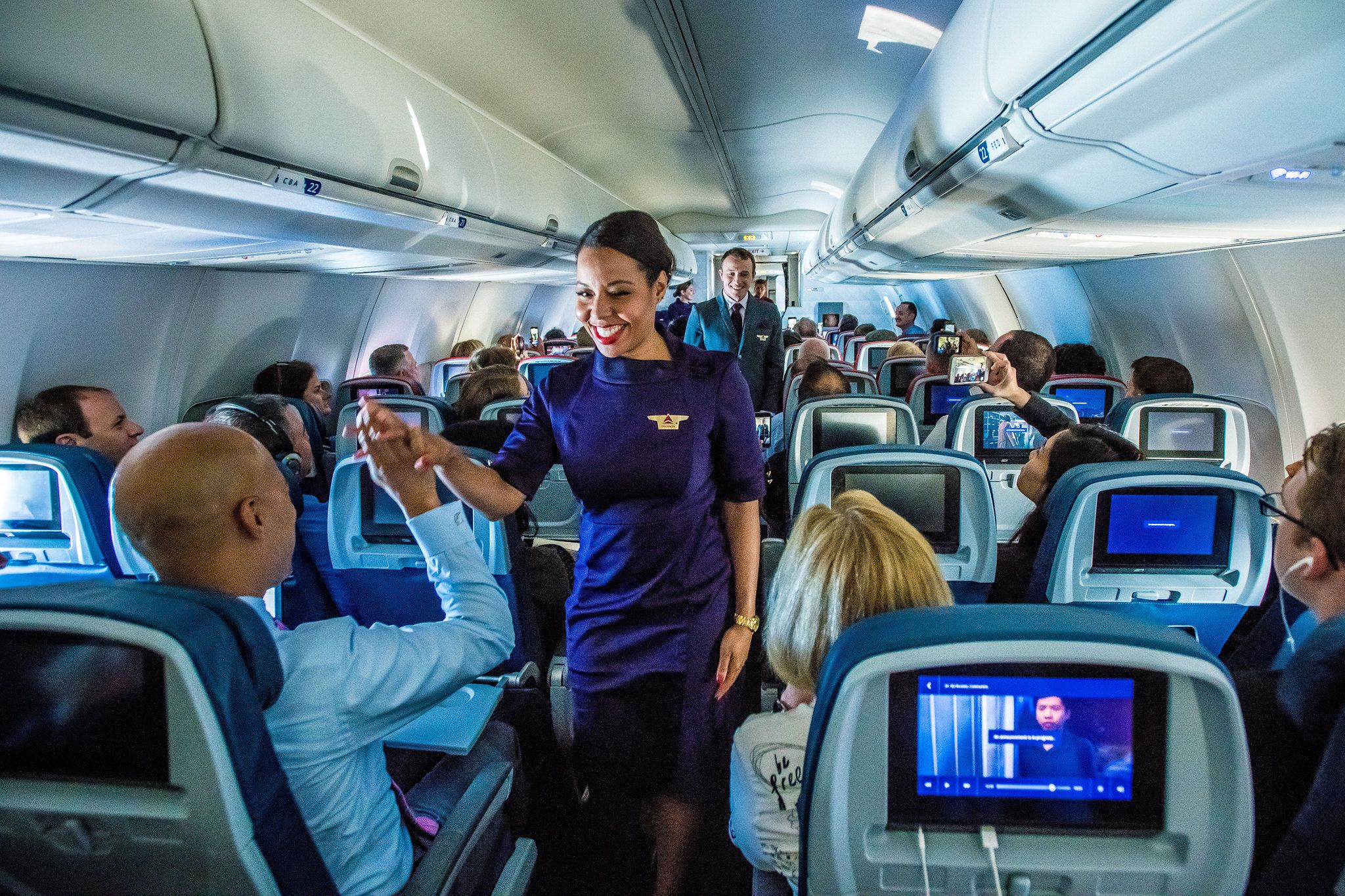 Delta Air Lines flight attendants working in the main cabin.