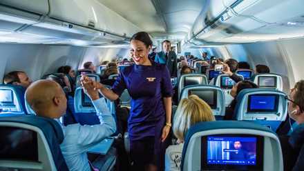Delta Air Lines flight attendants working in the main cabin.