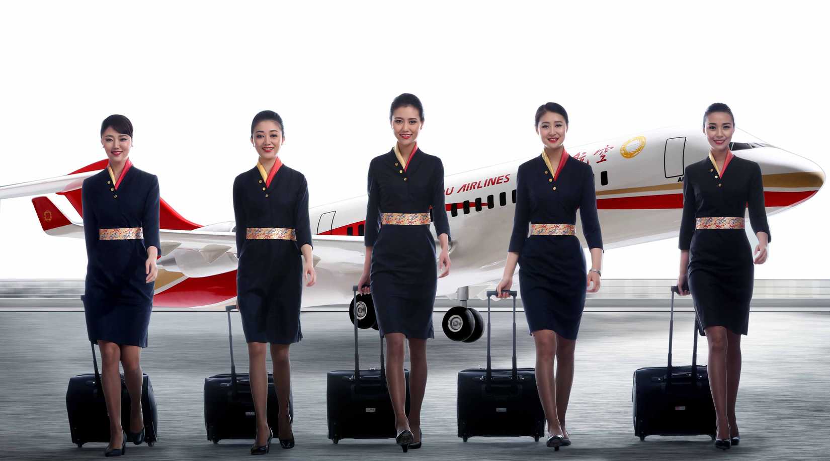 Several Chengdu Airlines Cabin Crew members walking with small suitcases in front of an aircraft.
