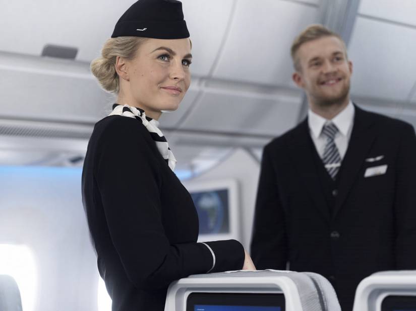 Finnair flight attendants working in the A350 economy class cabin.