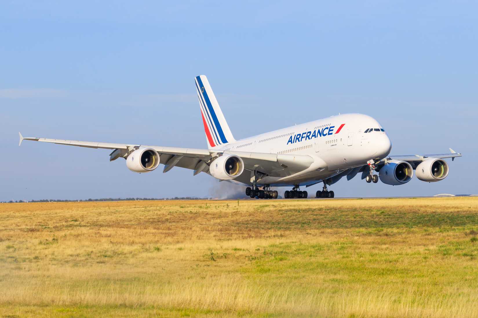 An Air France Airbus A380 landing on a runway.