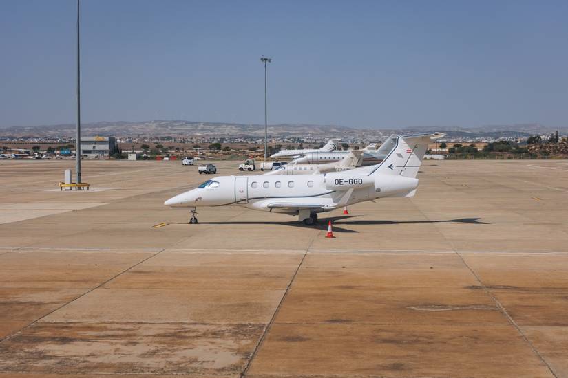 An Embraer Phenom 300 parked at an airport.