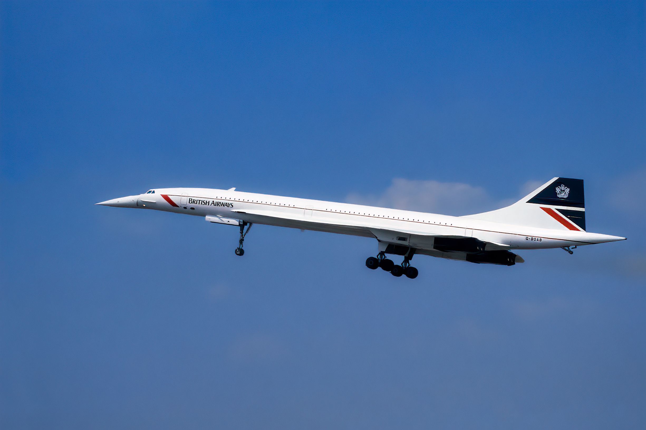 A British Airways Concorde taking off with landing gear still extended .