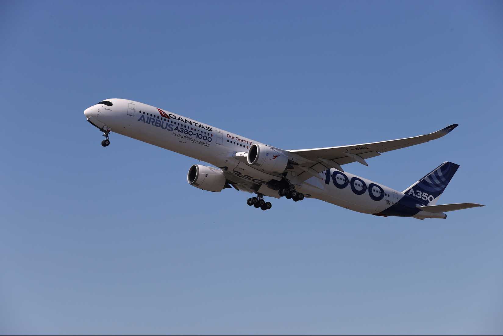 A Qantas Airbus A350-1000 flying in the sky.