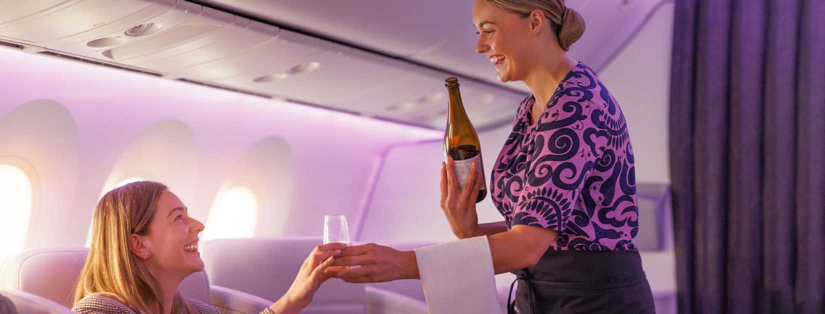 Air New Zealand flight attendant serving business premier