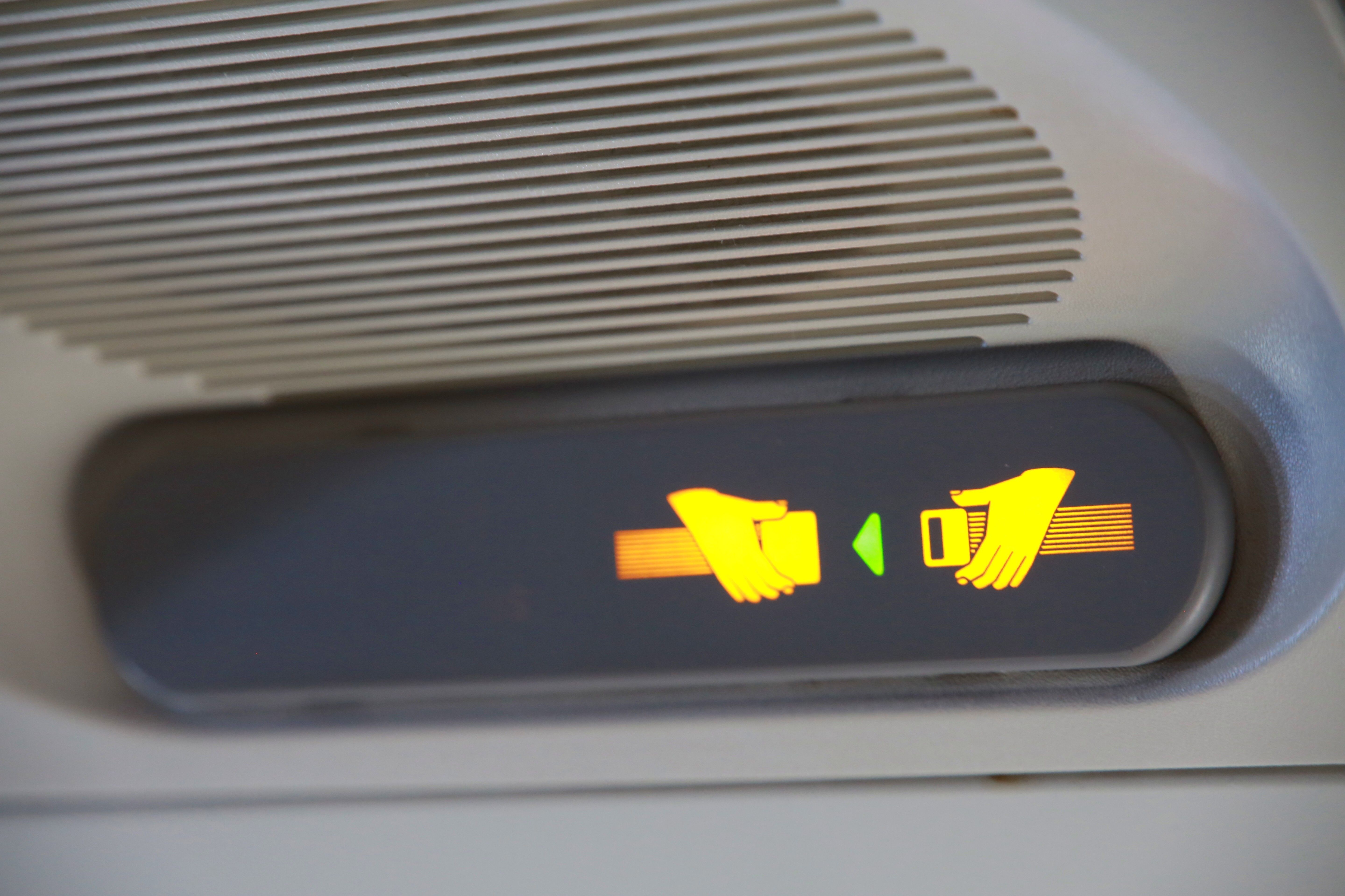 An Illuminated Fasten Seatbelt Sign in a Commercial Aircraft.