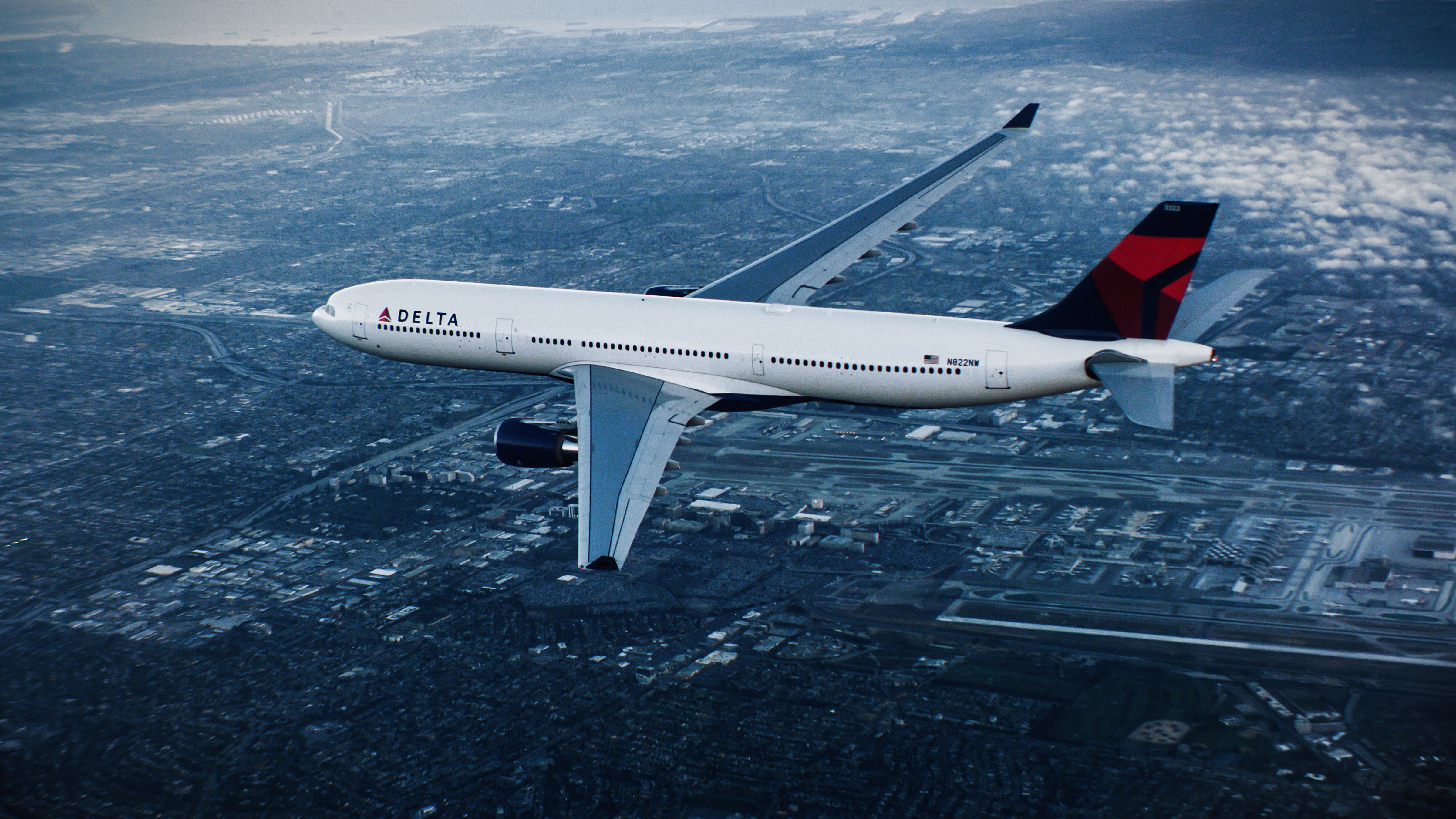 White Airbus A330 aircraft with Delta Air Lines livery flies over a city