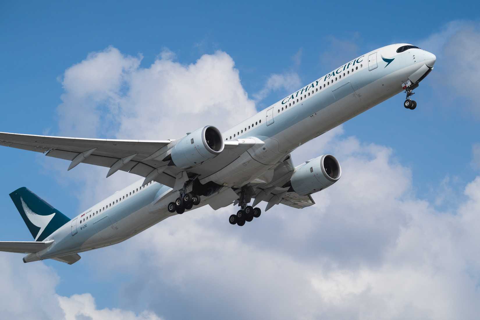 A Cathay Pacific A350-1000 flying in the sky.