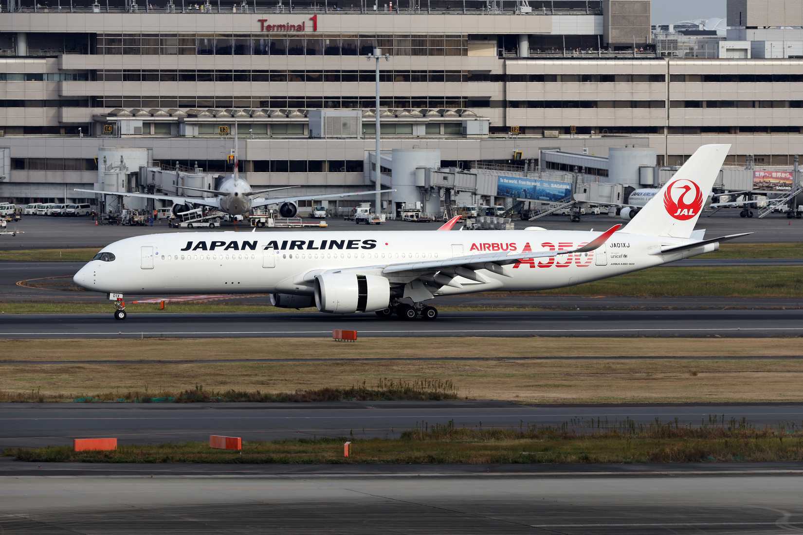 A Japan Airlines Airbus A350 on an airport runway.