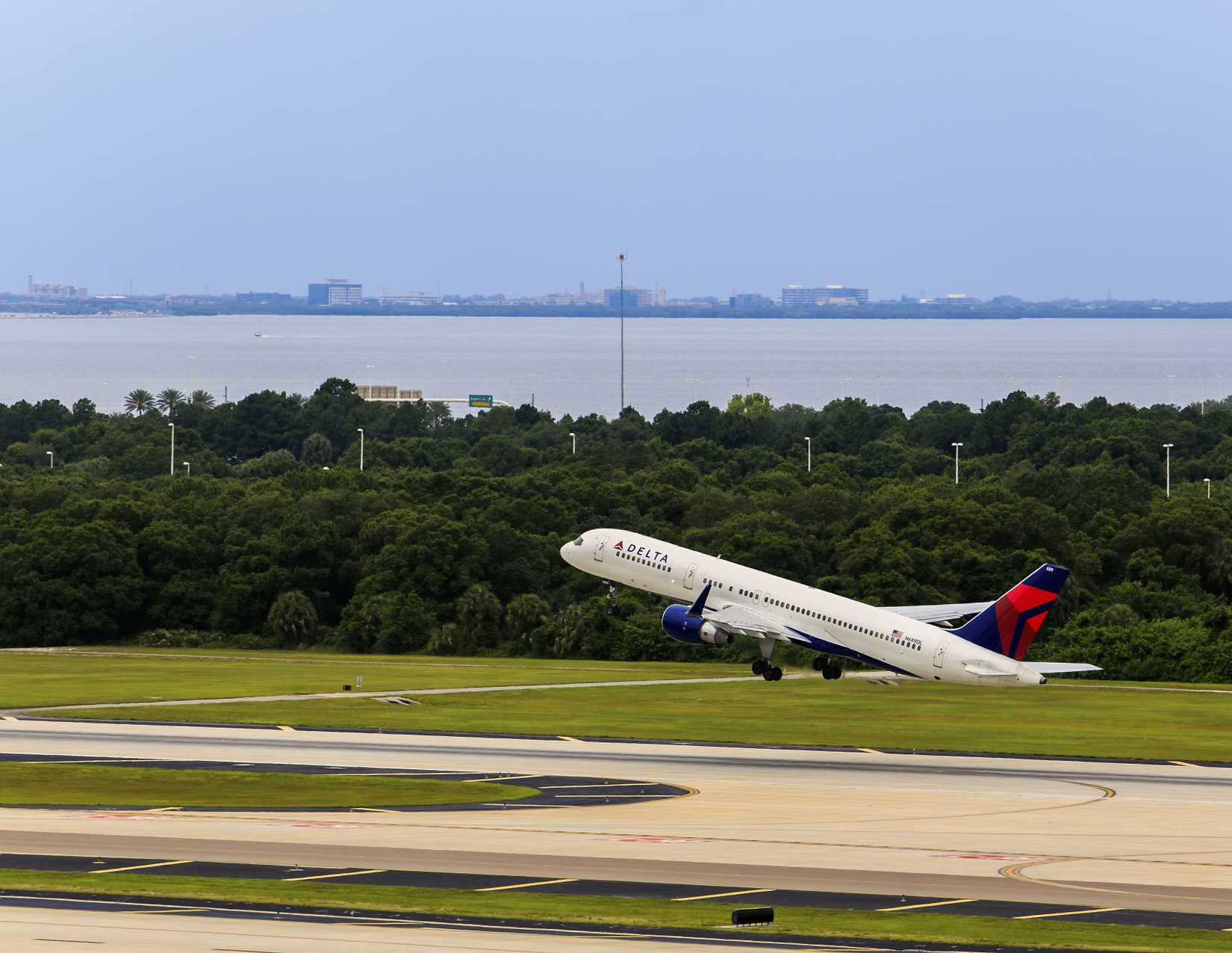 Tampa, Florida May 23, 2015 Tampa International Airport. A Delta Boeing 757 Jet Takes off with Tampa Bay in the background.