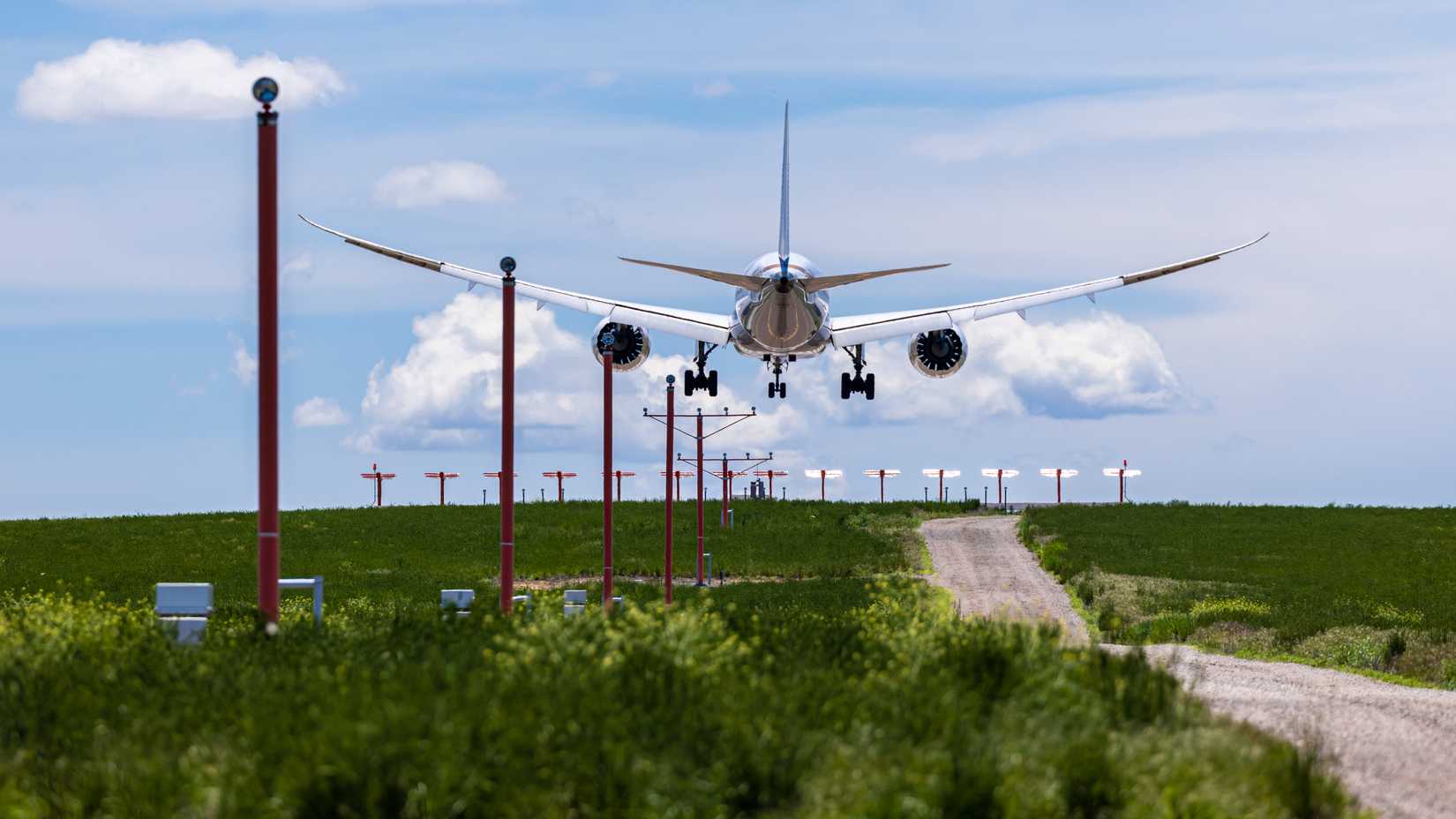 An aircraft touching down above the runway lights 
