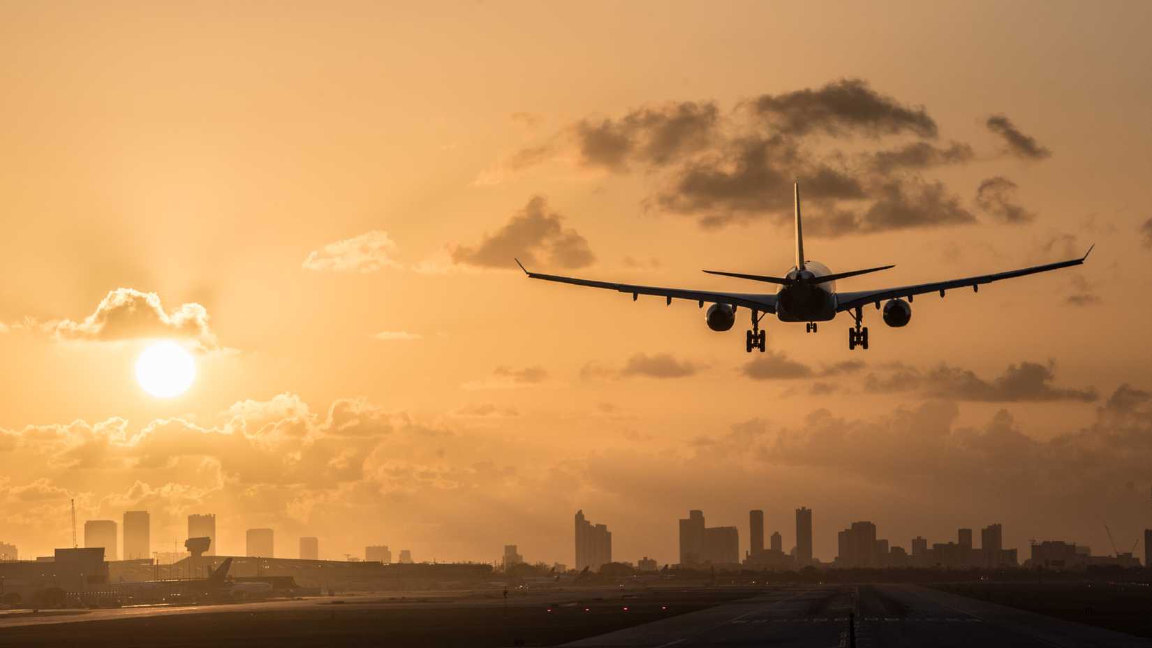 Aircraft Landing at MIA with Miami Skyline with Sunset