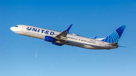 A United Airlines Boeing 737-900ER flying in the sky.