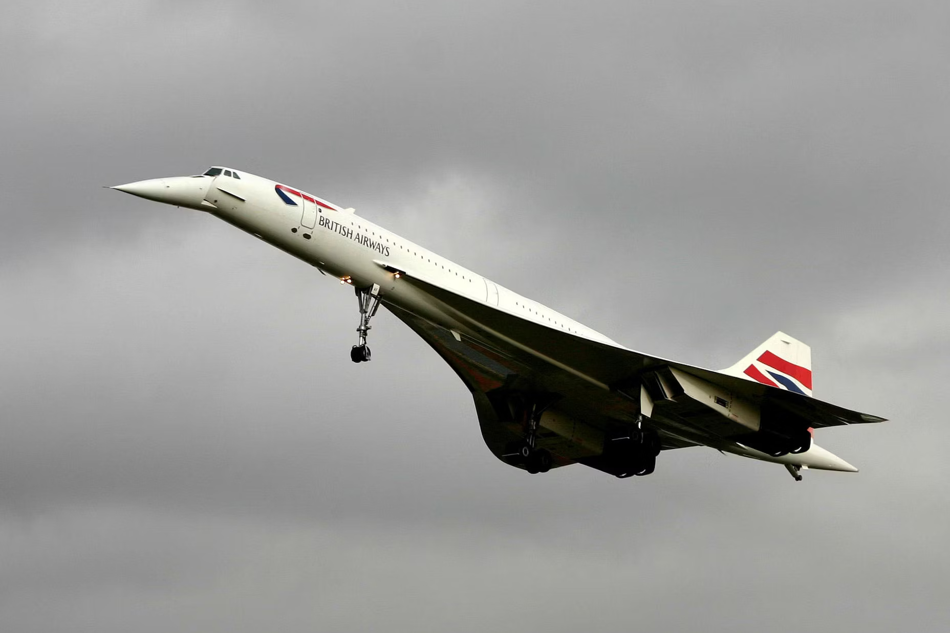 A British Airways Concorde flying below the clouds.