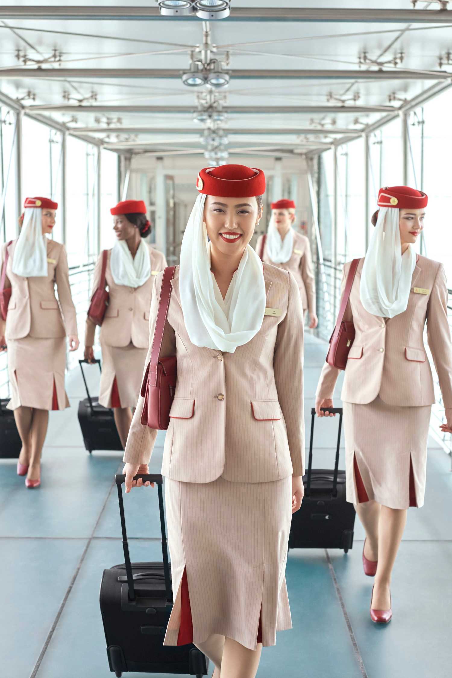 Emirates cabin crew walking on the jet bridge