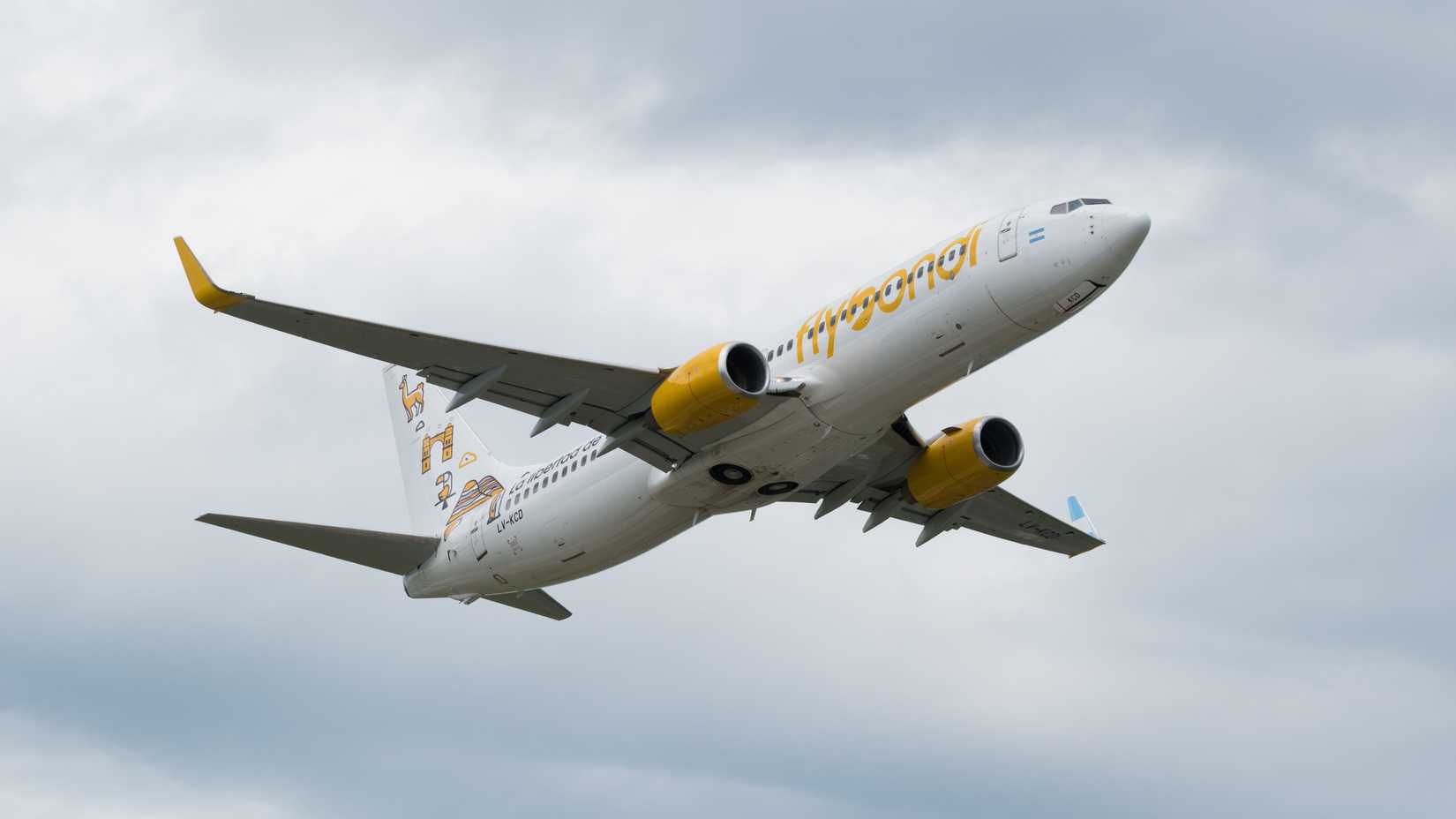   Cordoba, Argentina; Feb 05 2022_ Commercial plane of the Argentine airline Flybondi taking off on a cloudy afternoon