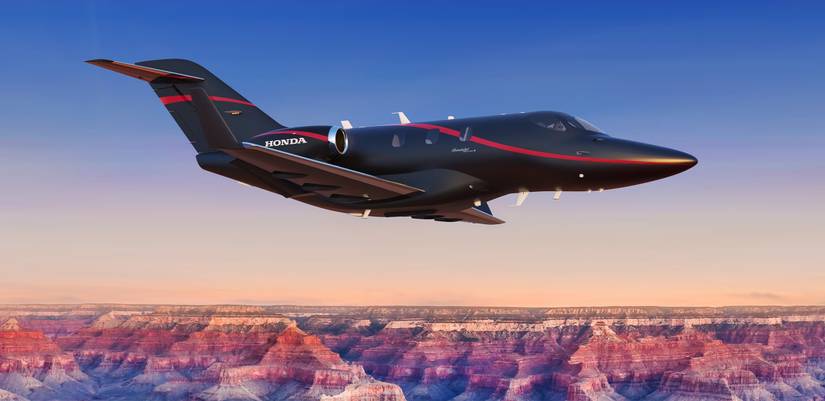 A HondaJet Elite II flying above the clouds.