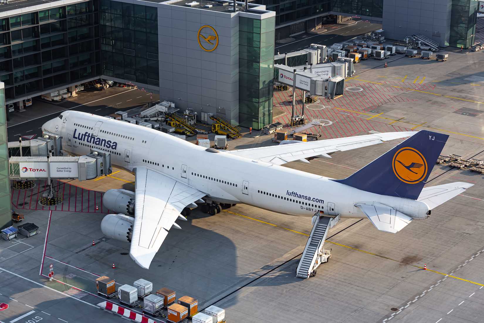 A Lufthansa Boeing 747-8 parked at a gate at Frankfurt Airport.