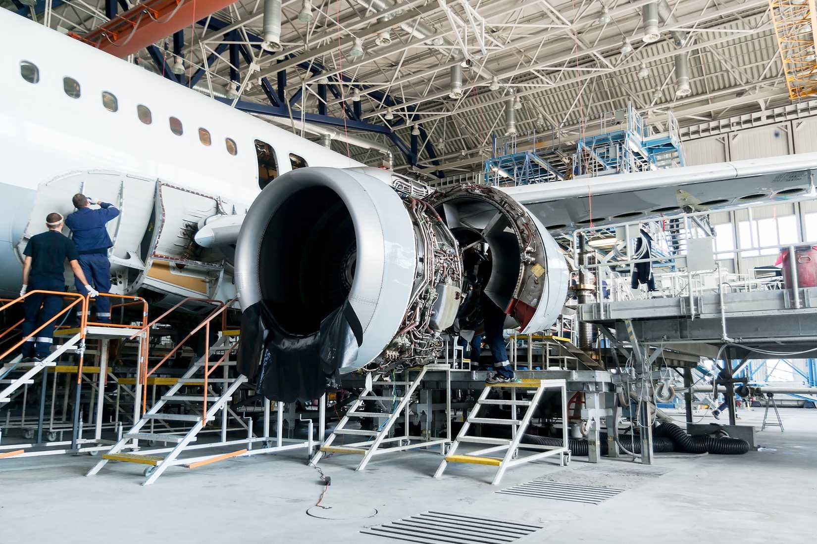 Maintenance technicians working on an aircraft in the Lufthansa Technik hangar.