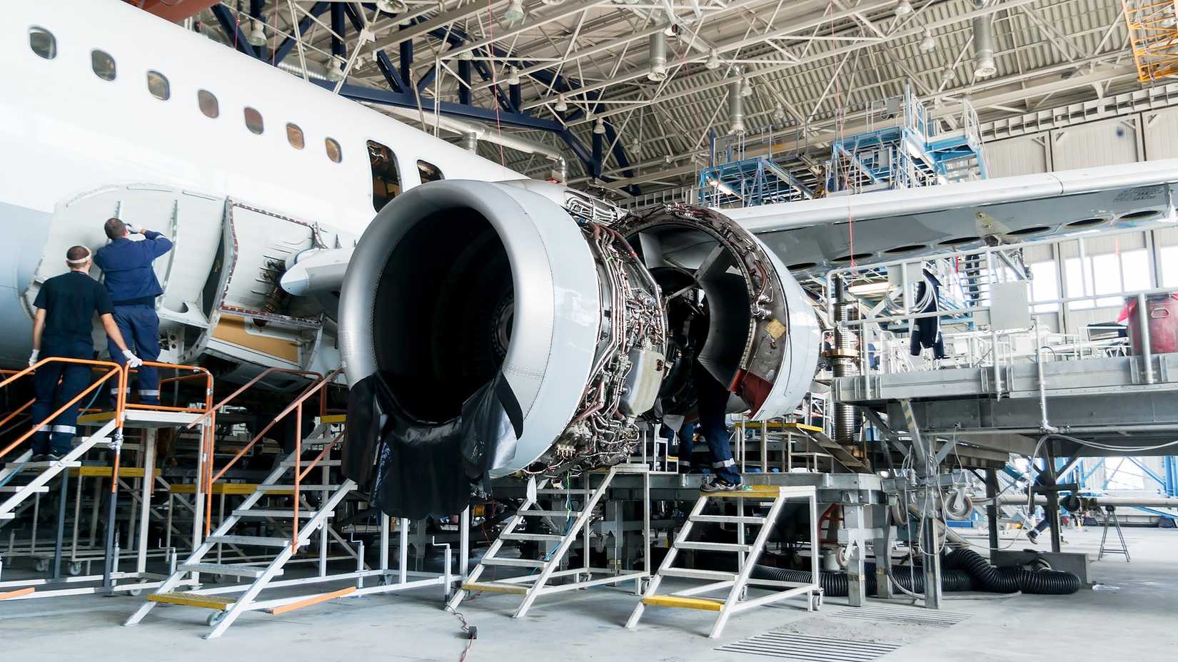 Maintenance technicians working on an aircraft in the Lufthansa Technik hangar.