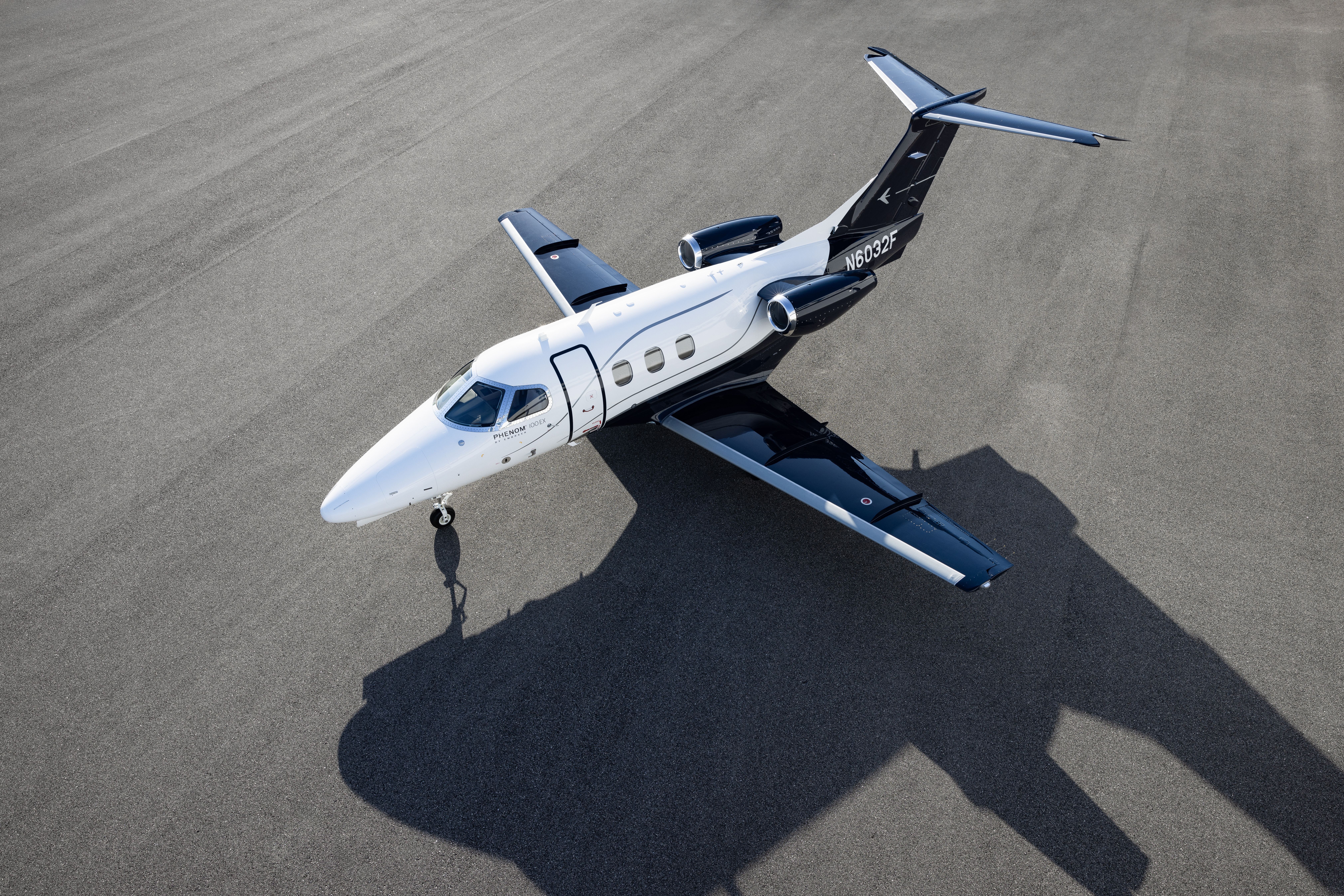 An Embraer Phenom 100EX on an airport apron.