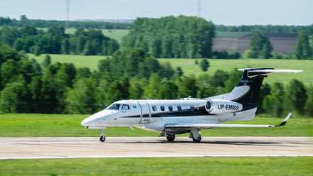 An Embraer Phenom 300 on an airport apron.