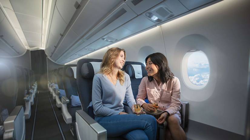 Two passengers chatting in the British Airways A380 World Traveller Plus Cabin.