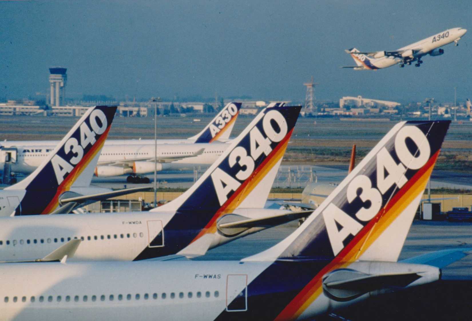 Tails of Airbus A330s and A340s parked