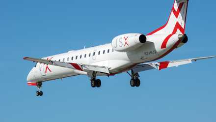 A JSX Embraer E145 flying in the sky.