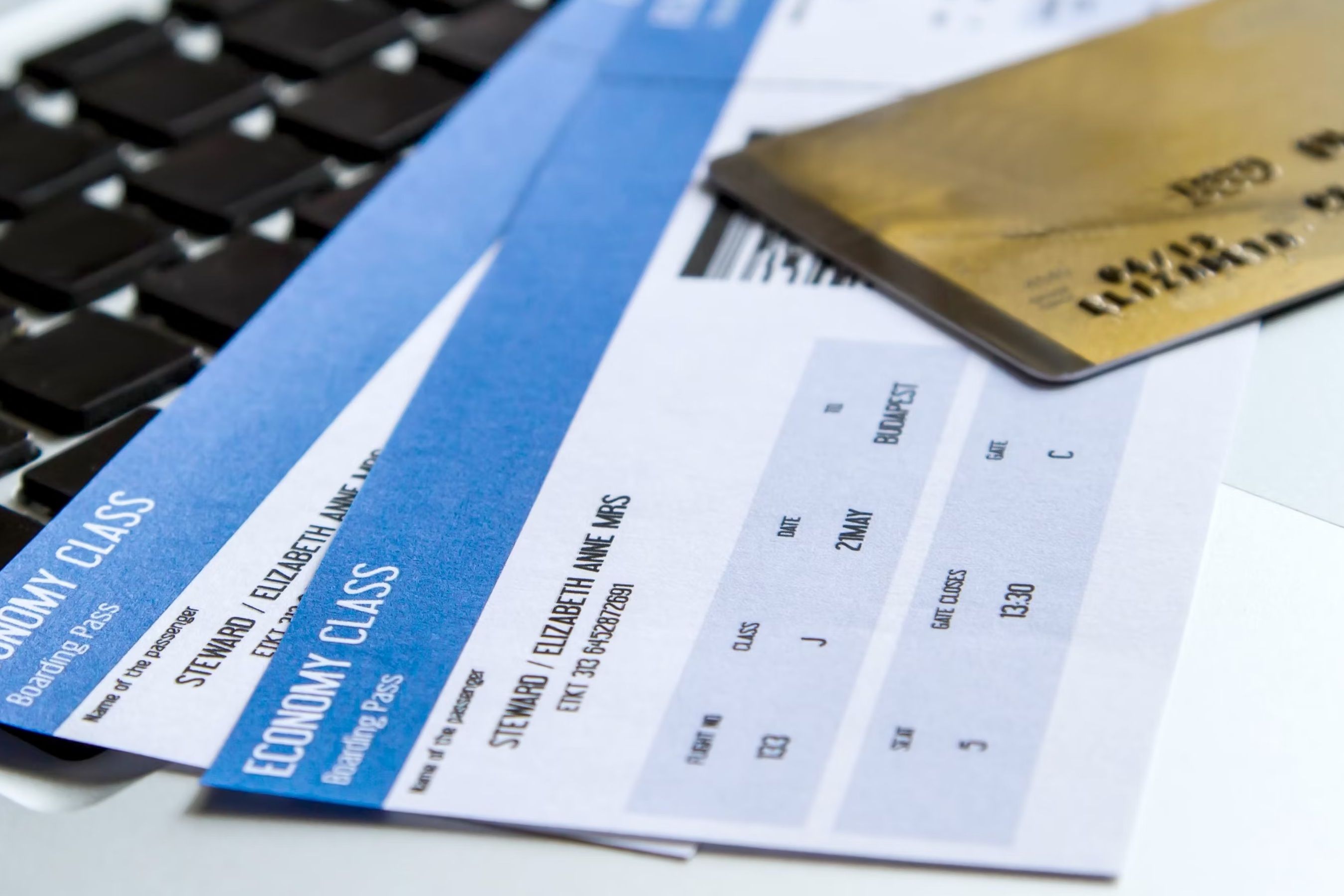 A generic photo of a credit card on top of two boarding passes.