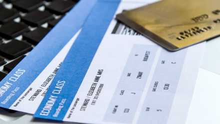 A generic photo of a credit card on top of two boarding passes.