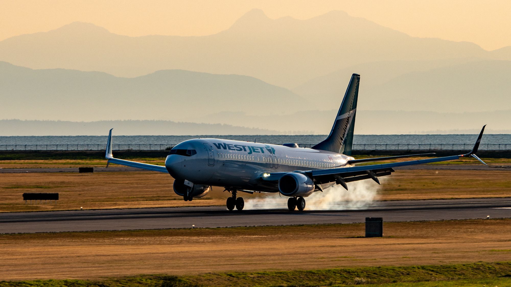 WestJet Boeing 737-800 touching down at Vancouver International Airport.